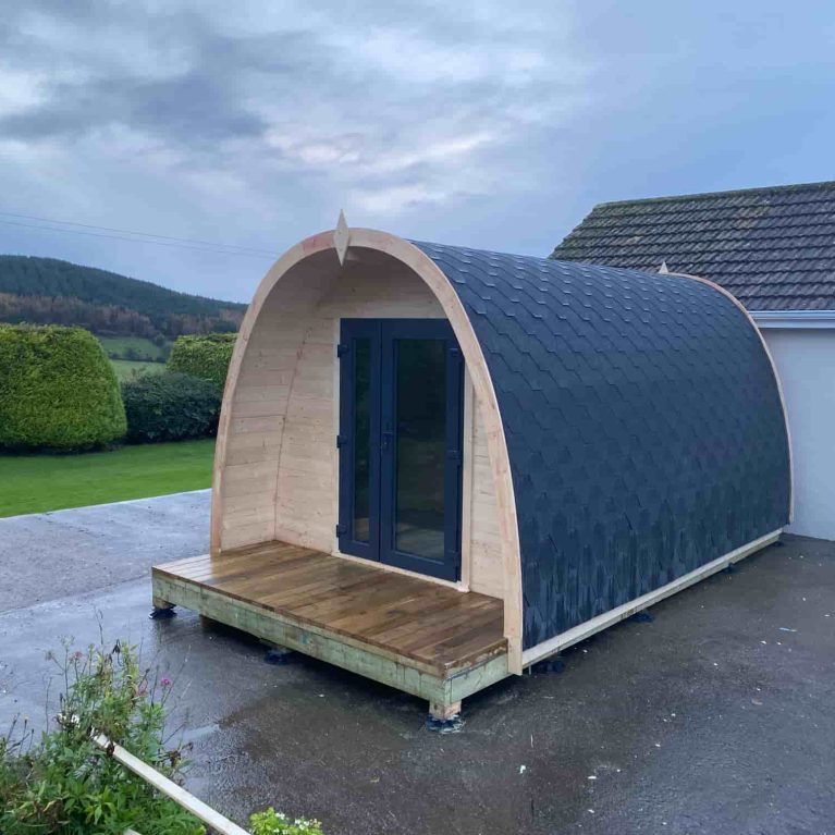 Garden log cabin surrounded by landscaped outdoor area