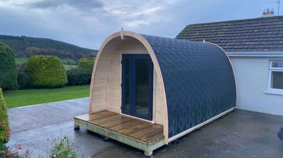 Garden log cabin surrounded by landscaped outdoor area