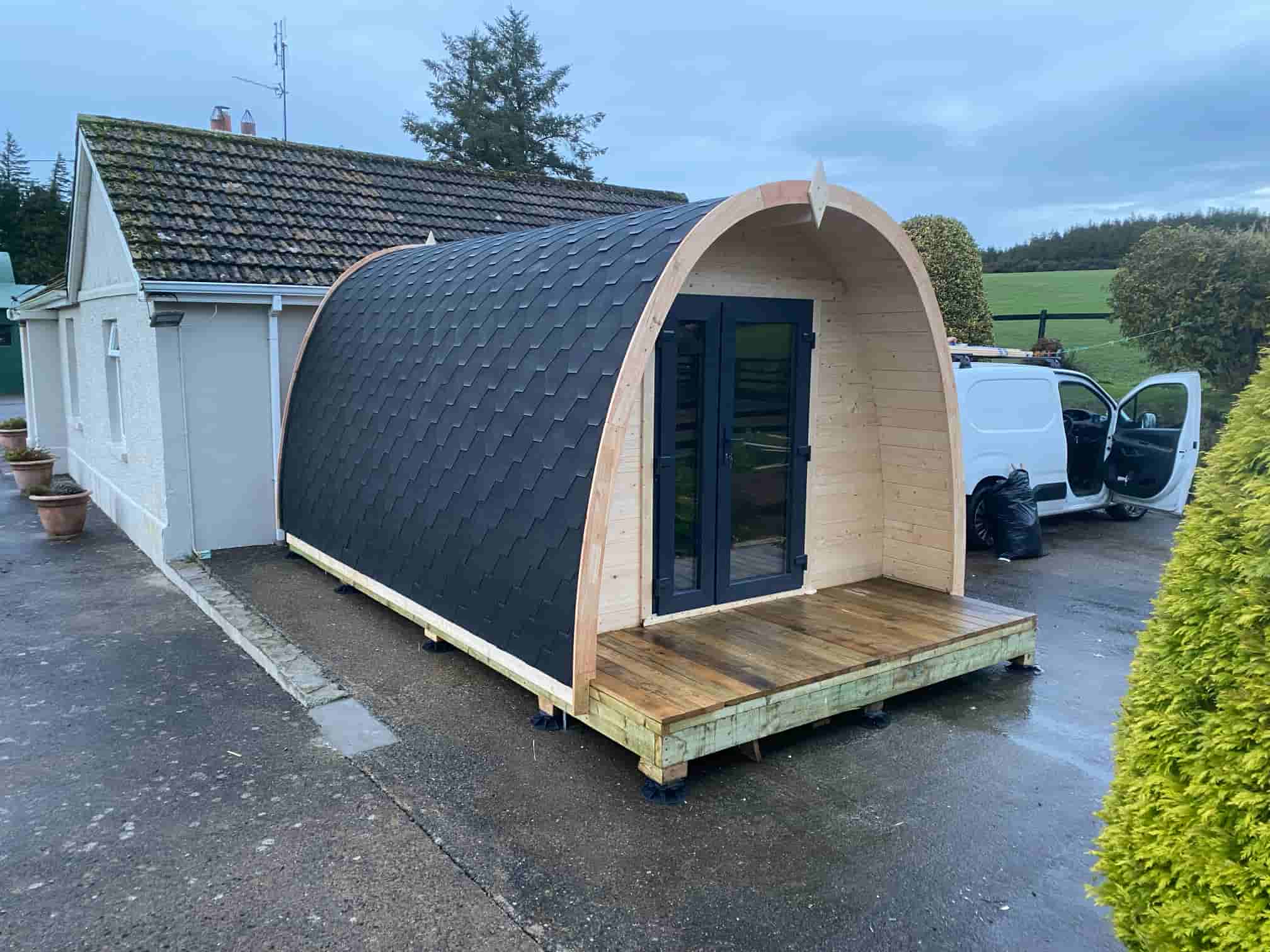 Igloo-style garden pod with curved timber roof and natural wood cladding